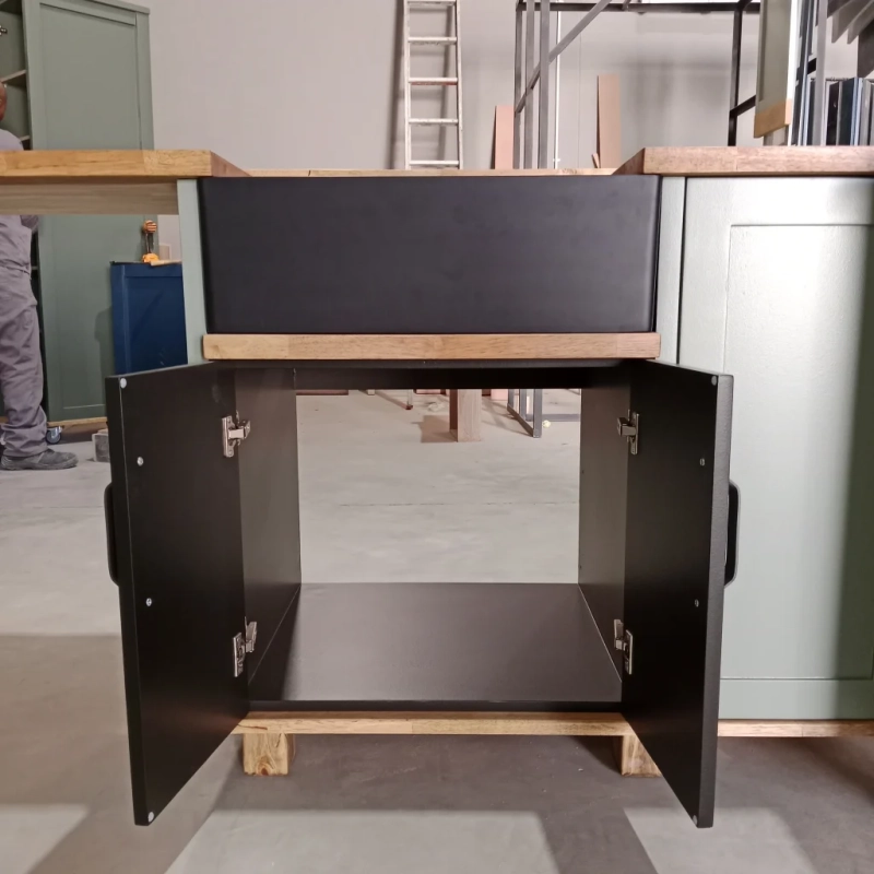 Black Single Butler Sink Cabinet Open A Front View Of A Black Single Butler Sink Cabinet's Open Cabinet In A Warehouse