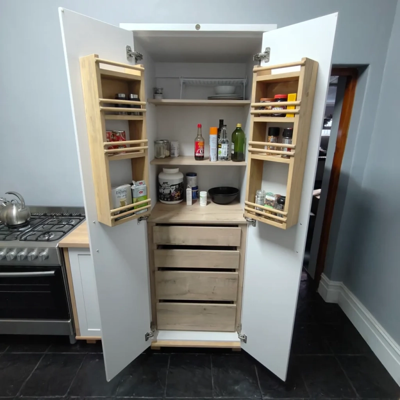 Deluxe Pantry White Open A front view of an open white deluxe pantry with shelves and spice racks in a kitchen