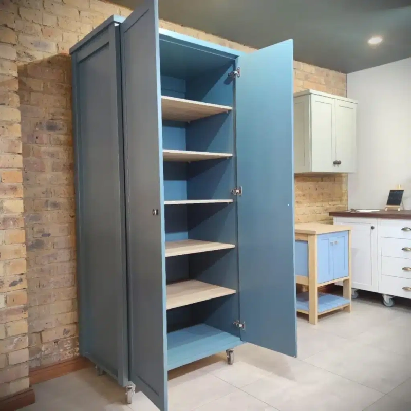 Double Door Pantry Blue Open. An open blue double door pantry in a kitchen