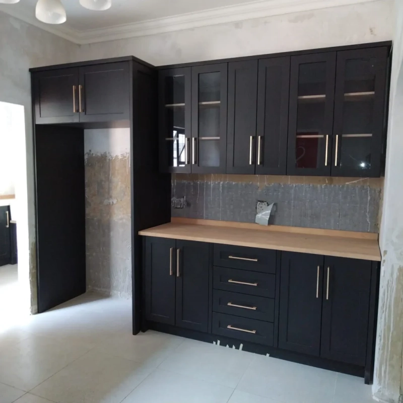A black fridge house unit in a kitchen