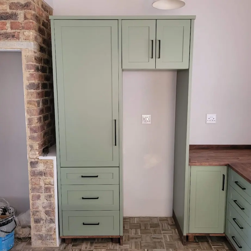A green fridge house unit in a kitchen
