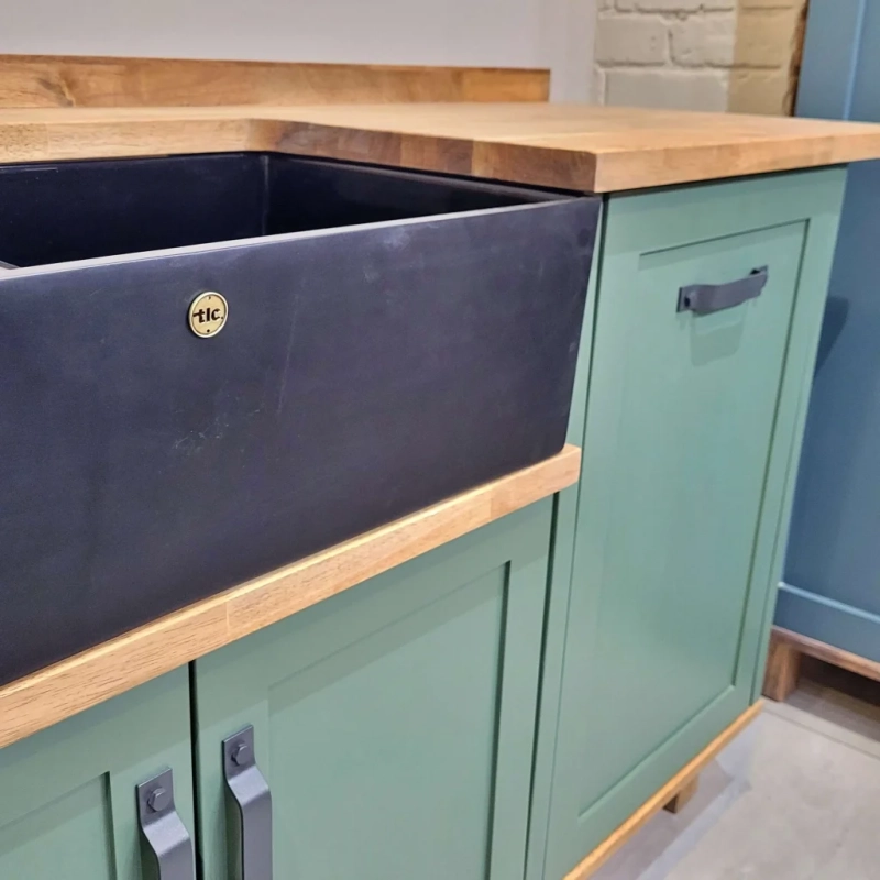 Green Double Butler Sink Kitchen Closeup A Left View Closeup Of A Green Double Butler Sink Cabinet In A Showroom