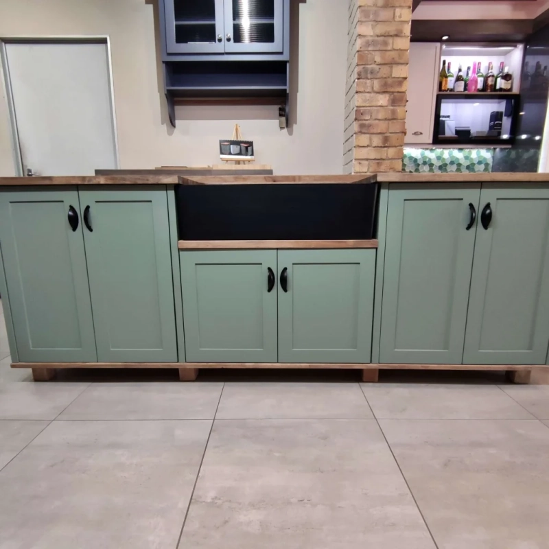 Green Double Butler Sink Showroom Front A Front View Of A Green Double Butler Sink Cabinet In A Showroom