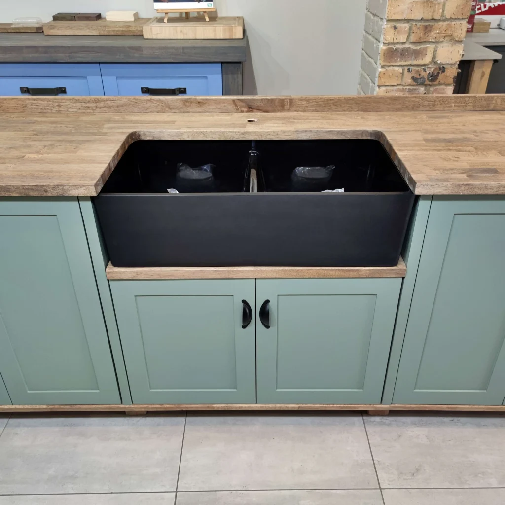 Green Double Butler Sink Showroom Top A Front View Closeup Of A Green Double Butler Sink Cabinet In A Showroom