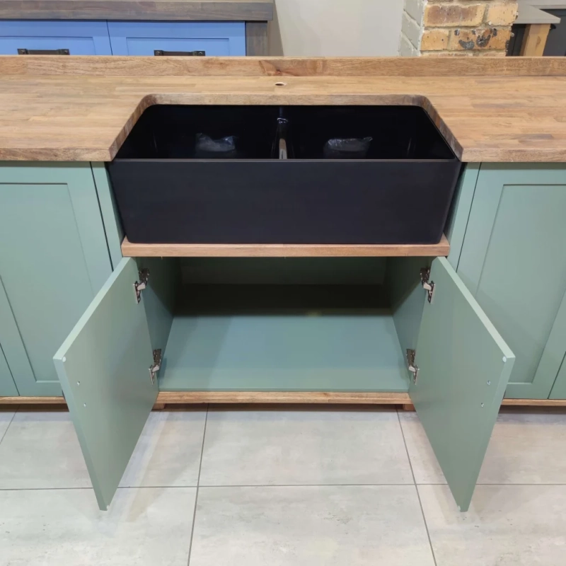 Open Green Double Butler Sink Showroom Top. A Front View Closeup Of An Open Green Double Butler Sink Cabinet In A Showroom