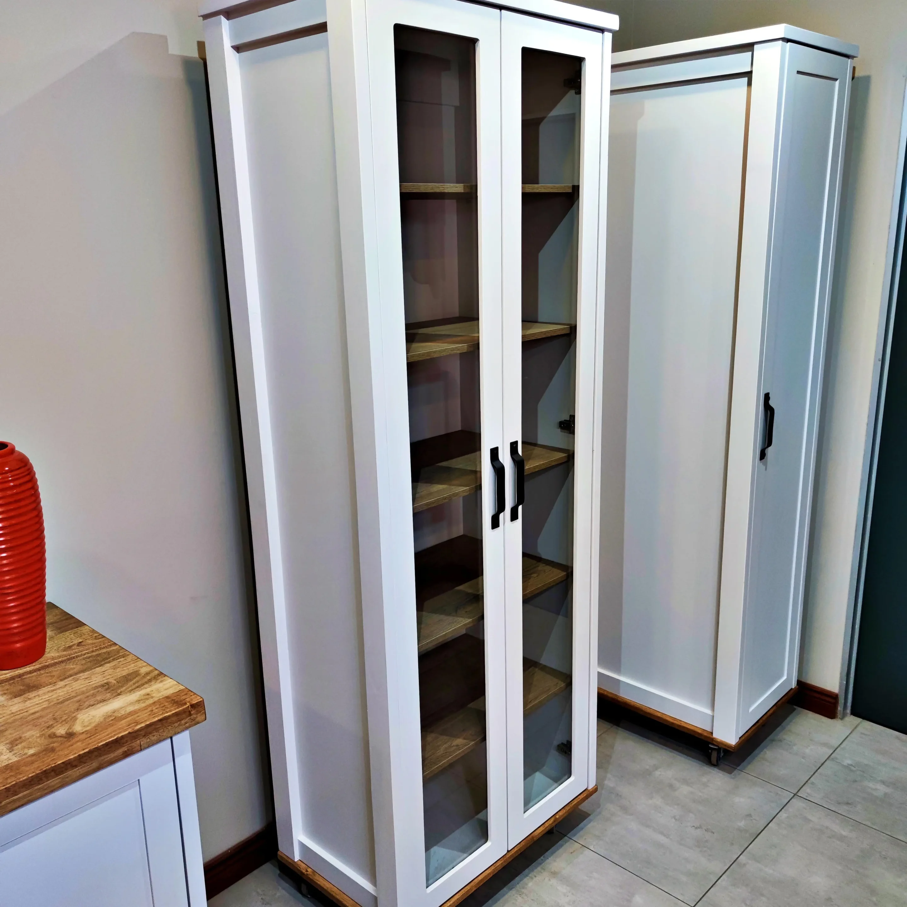 White Double Door Display Cabinet A White Double Door Display Cabinet In A Kitchen Next To Another White Unit