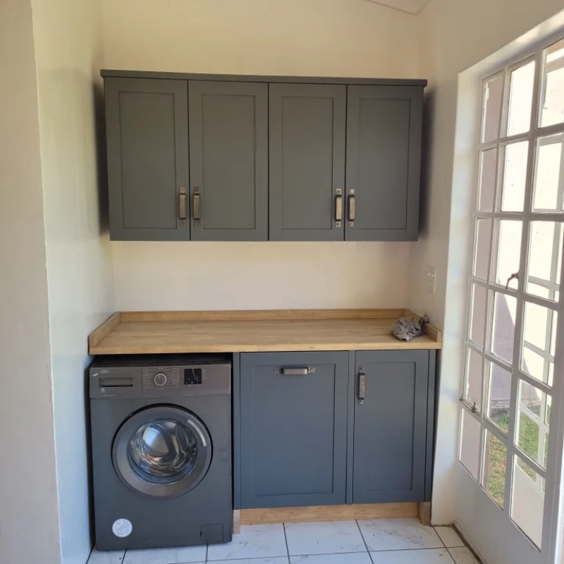 A Black Appliance Panel Cabinet With A Black Washing Machine In A Home