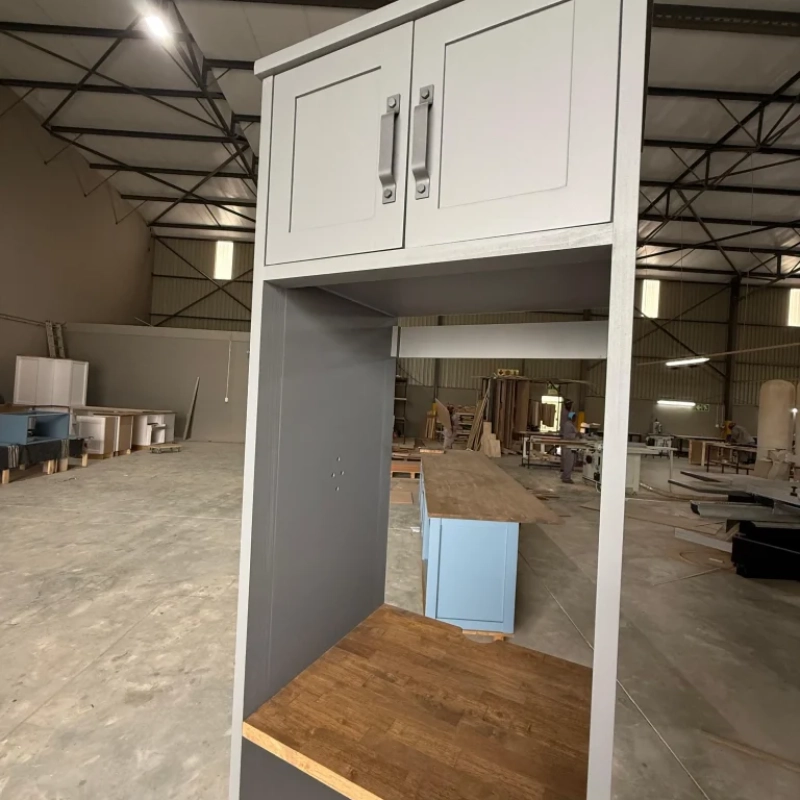 A Closeup Of A Blue Washing Machine House Cabinet In A Warehouse