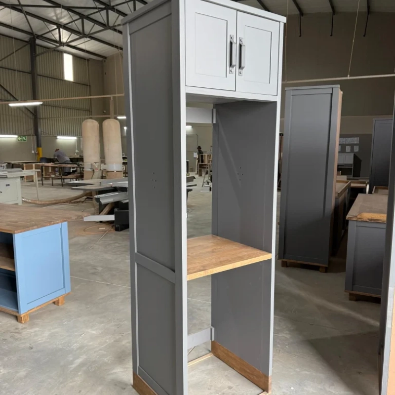 A Left View Of A Blue Washing Machine House Cabinet In A Warehouse