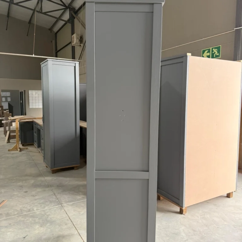 A Side View Of A Blue Washing Machine House Cabinet In A Warehouse