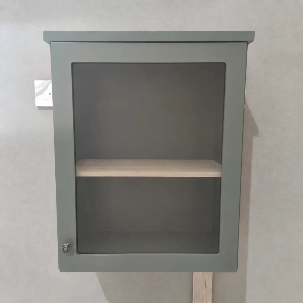 A Front View Of A Green Single Door Wall Cabinet In A Warehouse