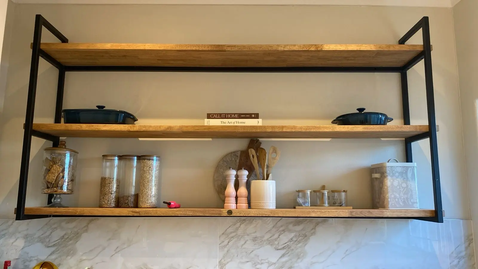 Three Tier Metalica Shelf With Books Kitchen A Three Tier Metalica Shelf With Books And Other Ornaments In A Kitchen