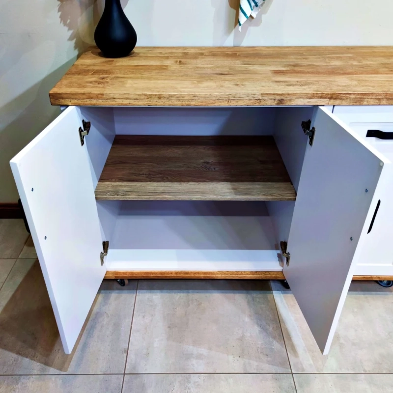 A Close Up Of A White Appliance Panel Cabinet's Doors Open