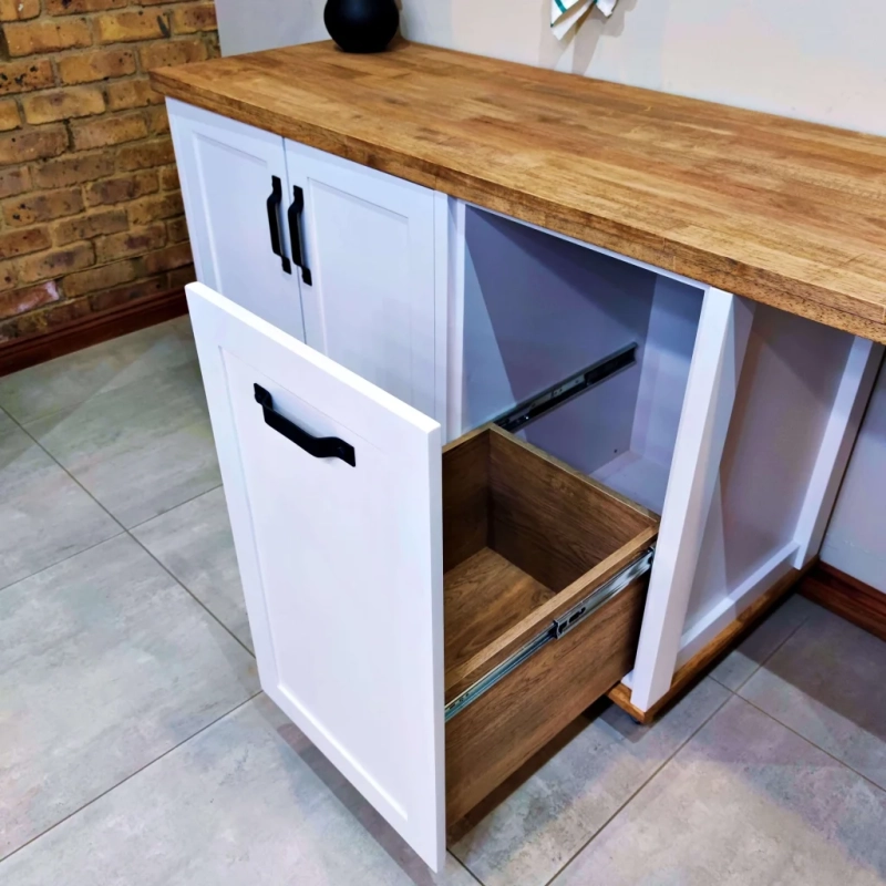 A Close Up Of A White Appliance Panel Cabinet's Drawer Open